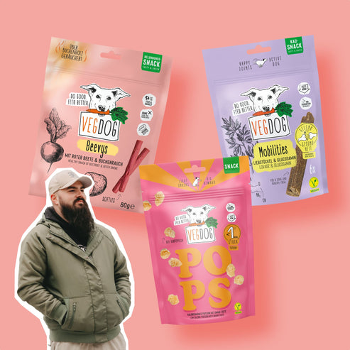 a man standing in front of several bags of food